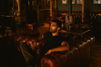 Man in Black Shirt Sitting on Sofa
