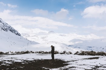 Man in Black Shirt Standing on White Snow Field