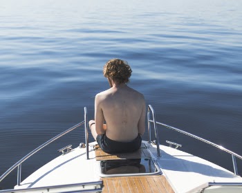 Man in Black Shorts on Boat End