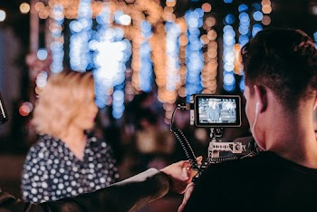 Man in Black Sleeve Shirt Holding Camera