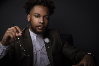 Man In Black Suit Jacket Holding Eyeglasses