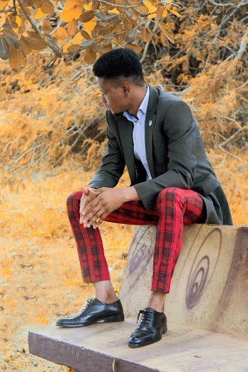 Man In Black Suit Sitting on Bench