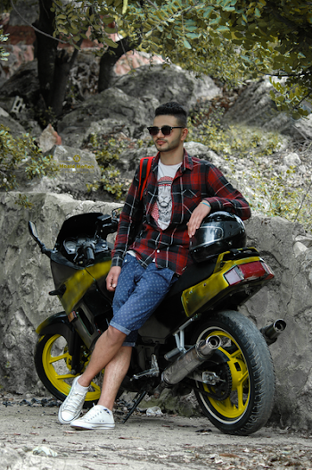 Man in Black Sunglasses Leaning Black Sportbike