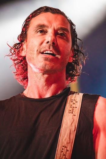 Man in Black Tank Top Playing Guitar