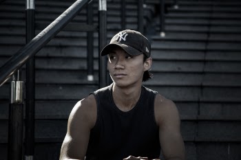Man in Black Tank Top Sitting on Staircase