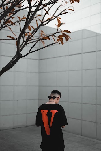 Man in Black Top Standing Outdoors