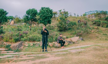 Man in Black Top Taking Photo Outdoors