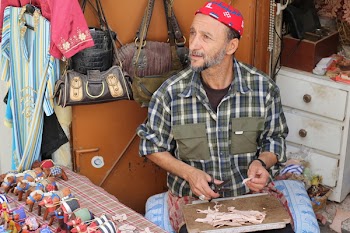 Man in Blue and White Plaid Shirt Holding Shears