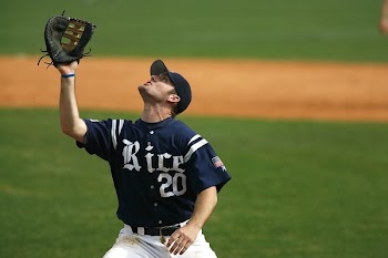 Man in Blue and White Rice 20 Jersey Looking Up during Daytime