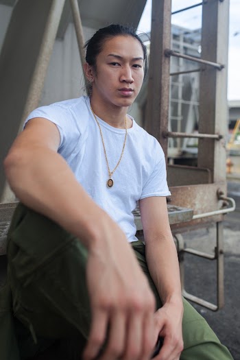 Man in Blue Crew Neck T-shirt and Green Pants Sitting on Stairs