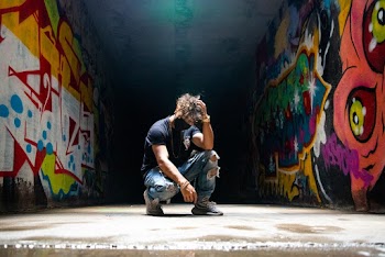 Man In Blue Denim Distressed Jeans And T-shirt