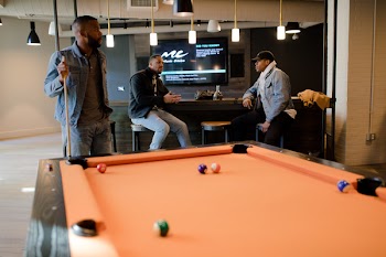 Man in Blue Denim Jacket Holding Cue Stick
