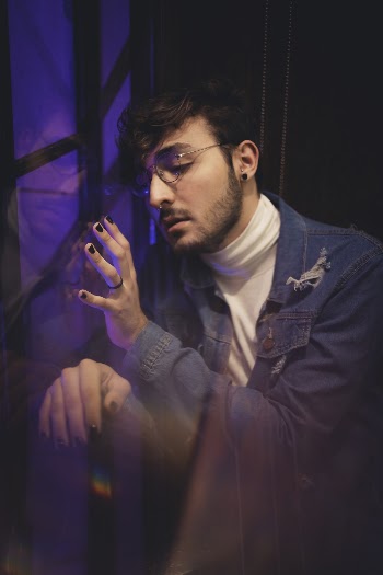 Man In Blue Denim Jacket Leaning On Window