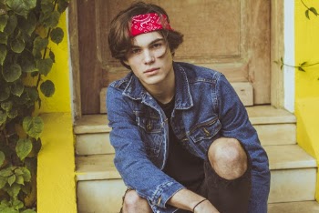 Man in Blue Denim Jacket Sitting on Stiars