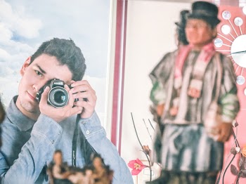 Man in Blue Denim Jacket Using Black Dslr Camera
