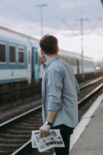 Man in Blue Dress Shirt Standing on Train Station · Free Stock Photo