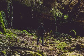 Man in Blue Jacket and Jeans Holding Stick