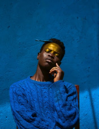 Man in Blue Knit Sweater Against Blue Wall