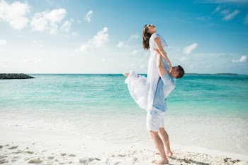 Man in Blue Shirt Carrying Woman in White Dress