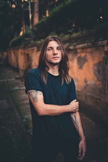 Man in Blue Shirt Standing on Pathway
