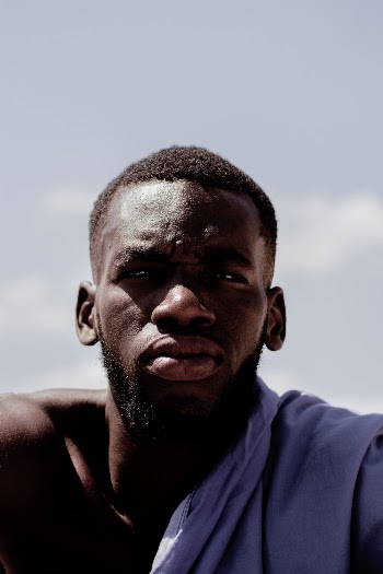Man in Blue Shirt Under Blue Sky