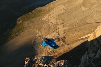man in blue suit skydiving