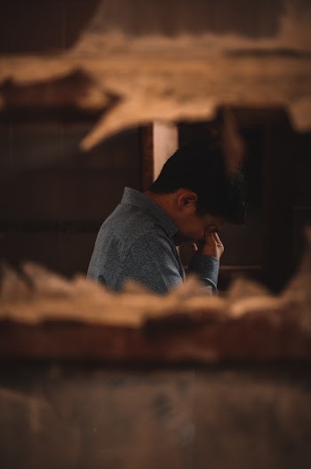 Man in Blue Top Facing Sideways