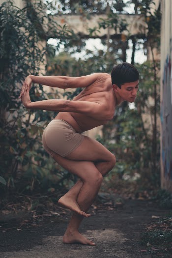 Man in Brown Boxer Shorts Doing Some Yoga Stretching