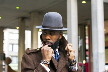 Man In Brown Coat And Grey Hat
