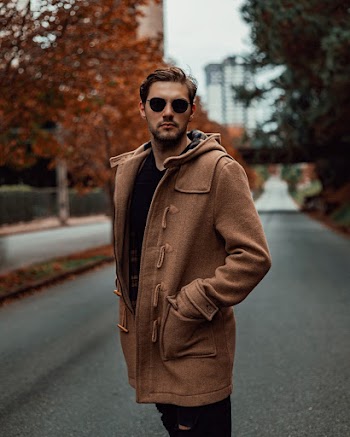 Man in Brown Coat Standing on the Street