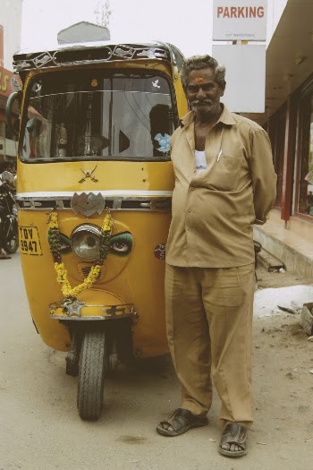 Man in Brown  Shirt Standing Beside Yellow Auto-rickshaw