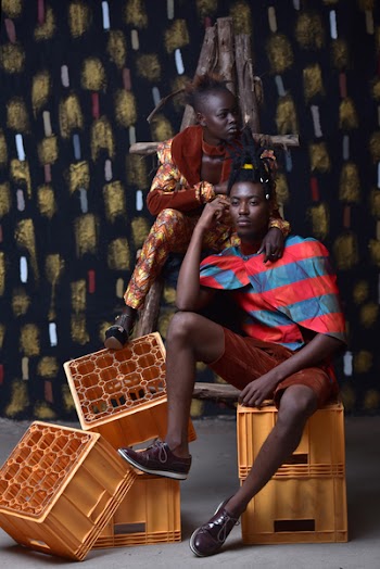 Man in Brown Shorts Sitting Beside Woman in Orange Jumpsuit on Yellow Plastic Crates