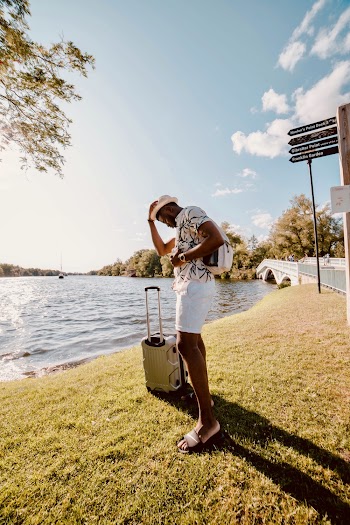 Man In Casual Wear Standing Near A Body Of Water