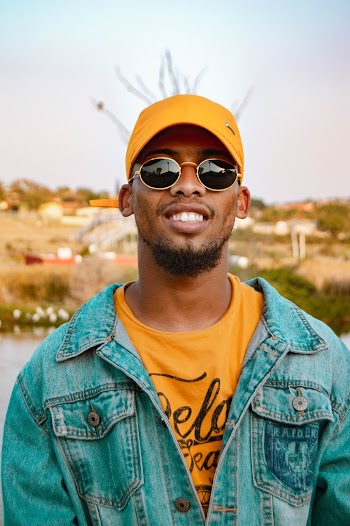 Man in Denim Jacket Yellow Cap and Sunglasses Smiling