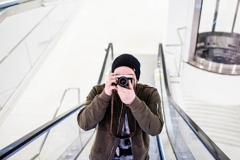 man in escalator taking photo
