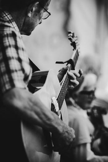 Man in Eyeglasses Playing Guitar