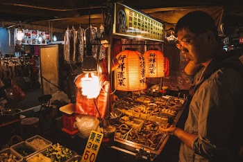 Man In Front Of A Food Stall