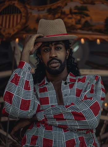 Man in Gray and Red Checkered Button-up Blazer and Brown and Red Hat