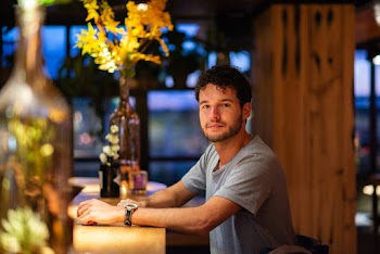 Man in Gray Crew-neck Shirt Sitting Indoors