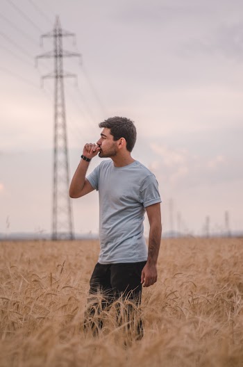 Man in Gray Crew-neck Shirt Standing in Crop field