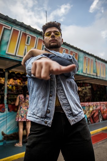 Man in Gray Denim Jacket Near Store