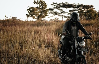 Man in Gray Jacket Riding Motorcycle