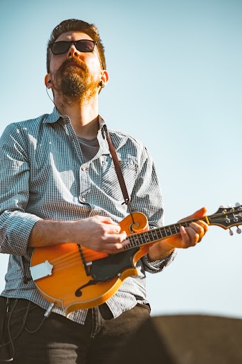 Man in Gray Shirt Playing Guitar