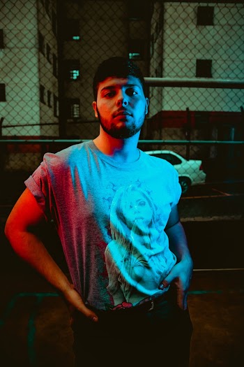 Man in Gray Shirt Standing Outside during Nighttime
