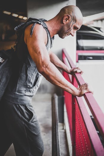Man in Gray Sleeveless Top and Black Sweat Pants