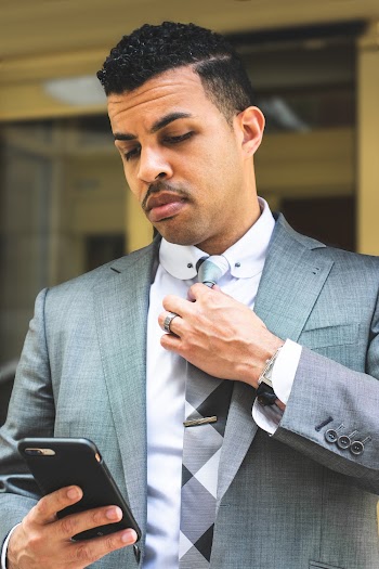 Man in Gray Suit Jacket Using Black Smartphone