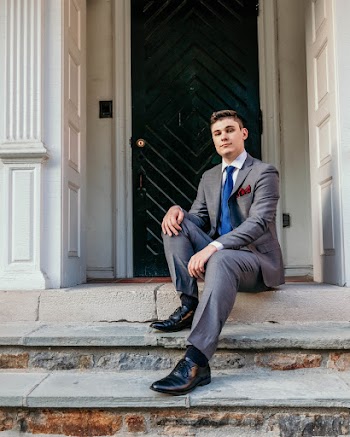 Man in Gray Suit Sitting on Gray Concrete Stairs