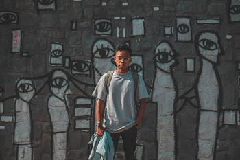 Man in Gray T-shirt Holding Jacket