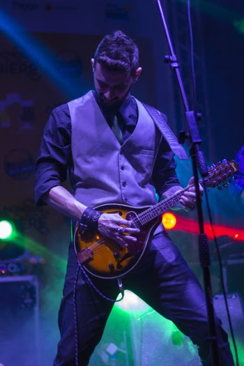 Man in Gray Vest Holding Mandolin