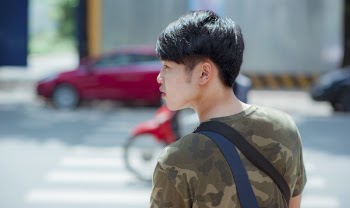 Man in Green and Gray Camouflage Shirt